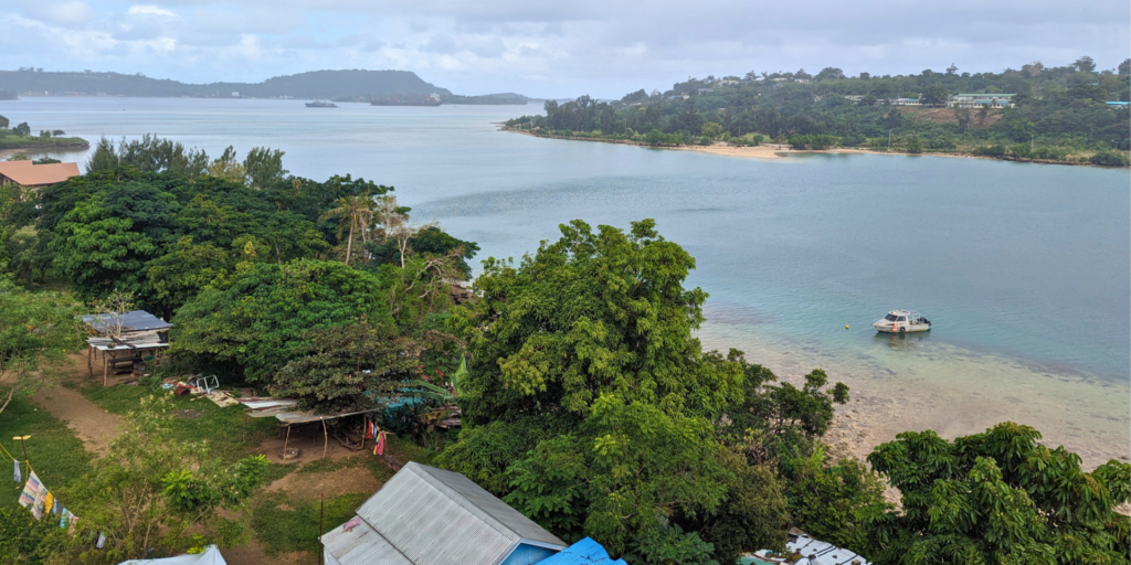 Vanuatu affordable climate-resilient housing. Buildings off Lini Highway, Port Vila, next to beach and waterway.